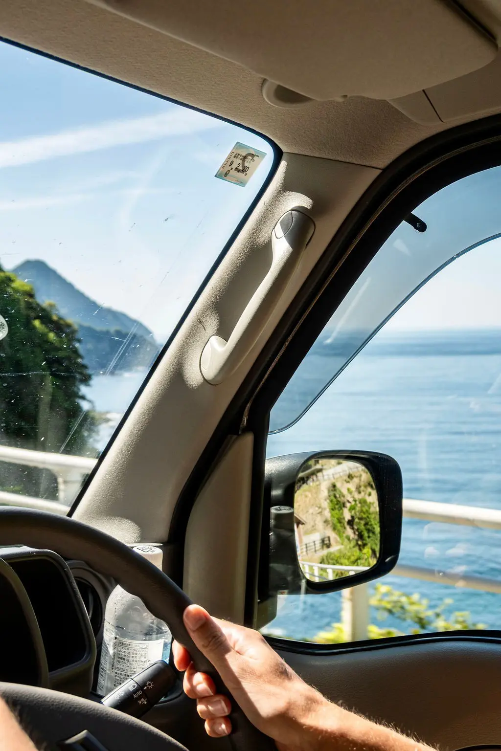 driving along the coast in Japan with a view of the sea
